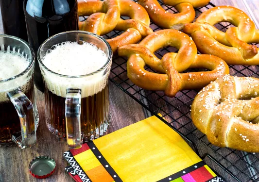 Glasses of beer and soft pretzels.