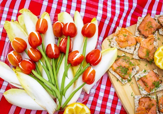Close-up of food spread, salmon, green beans, peppers, cheese, etc.