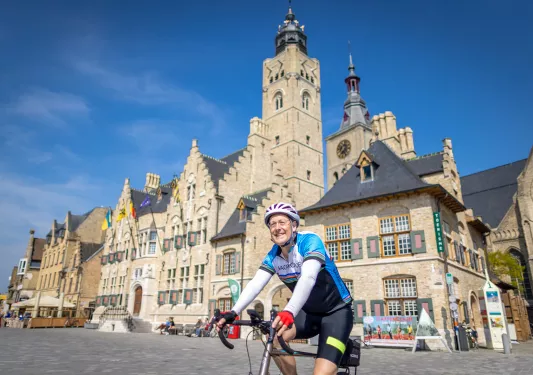 Biker smiling while biking through local town