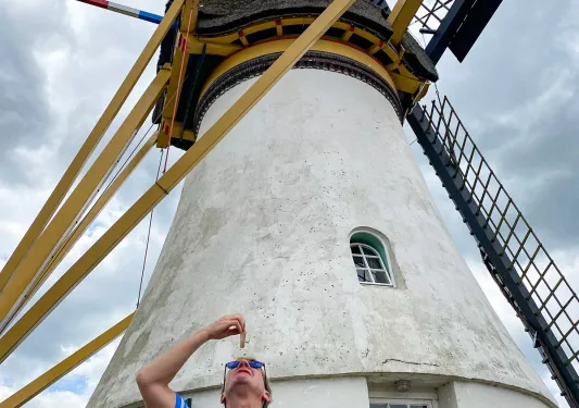 Guest standing underneath a windmill