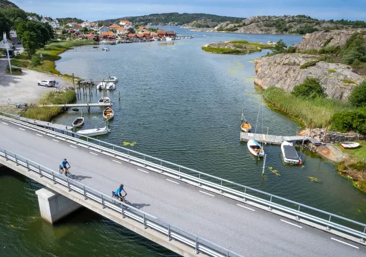 Two bikers riding over a bridge in Norway
