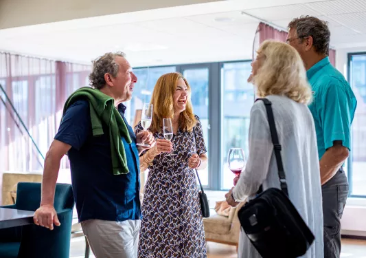 Group of guests laughing and socializing in a hotel
