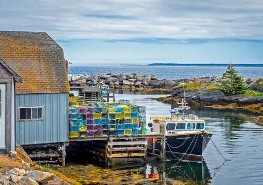 Shot of fishing vessel at port and lobster/crab traps.