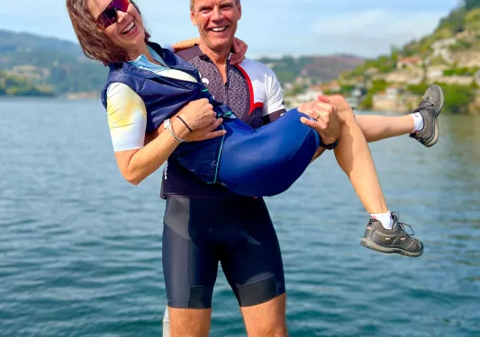 Two bikers posing on a dock in Portugal.