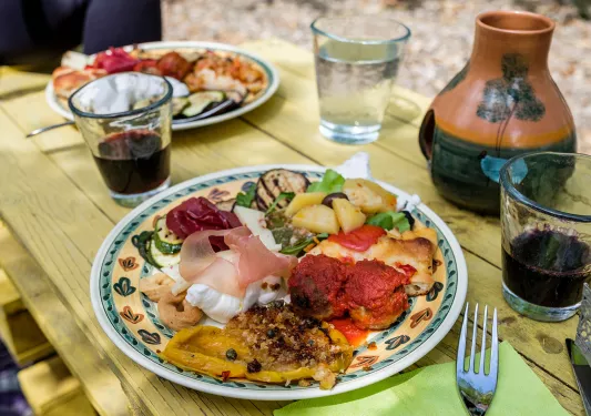 Platter of food, cheese, cured meats, meatballs, fruits, etc.