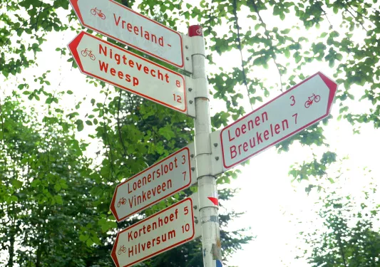 Street signs in town pointing multiple directions