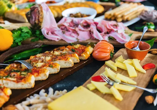 Food spread, cured meat, cheese, tomato, pizza bread, etc.