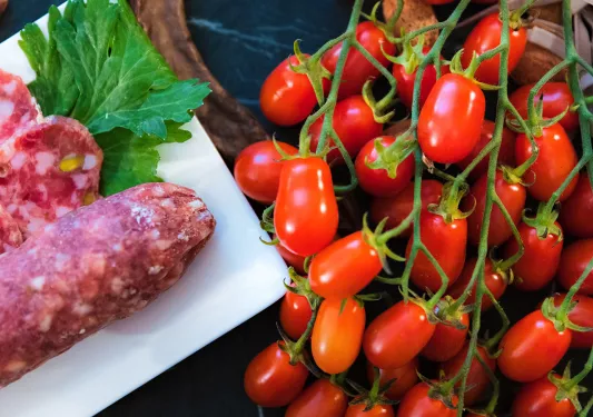 Close-up of cherry tomatoes and salami.