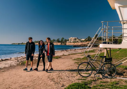 People walking along California beach.