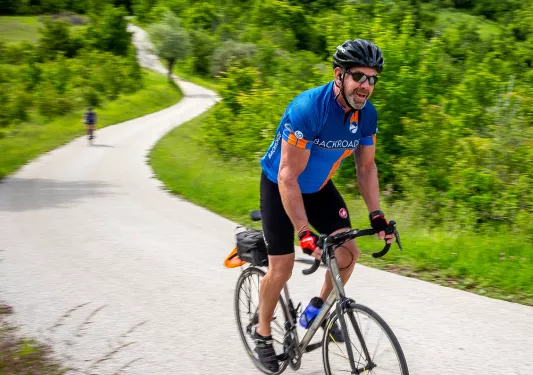 Biking along a winding road in Slovenia
