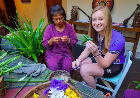 Backroads guest sitting with a local in Thailand