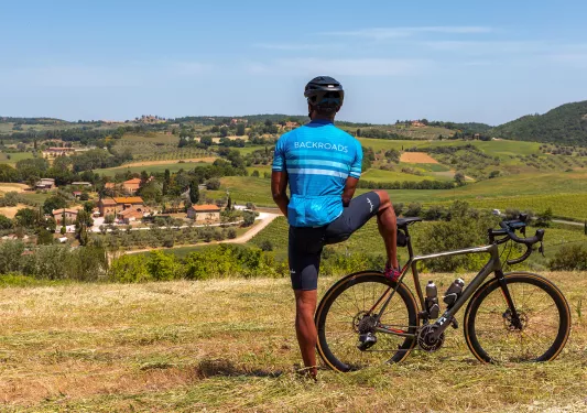 Rear shot of guest with bike, looking towards vineyard town.
