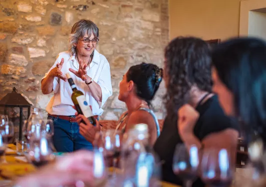 Four guests at dinner, talking wine with local.
