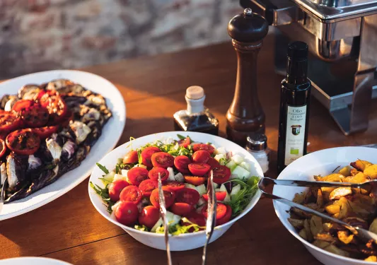 Close-up of three food platters during sunset.