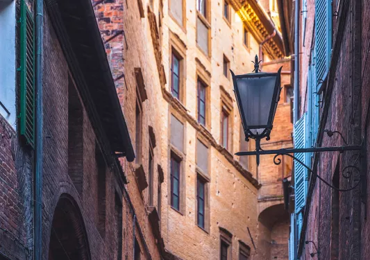 Shot of Italian alleyway, tall buildings, lamp.