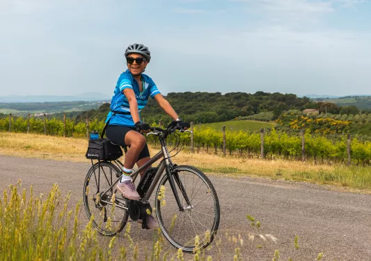 Guest cycling down countryside road.