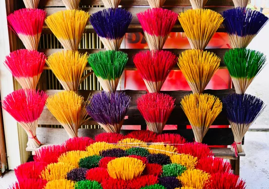 Large array of colorful incense sticks. 