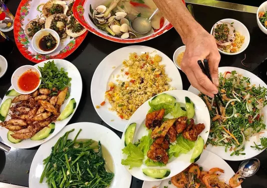Spread of Vietnamese food, fried rice, meat, seafood, veggies, etc.