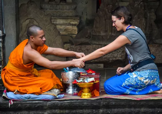 Guest and monk, monk giving blessing.