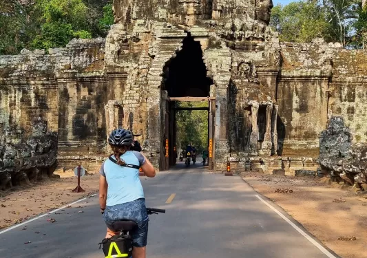 Biker riding toward Angkor Wat in Cambodia