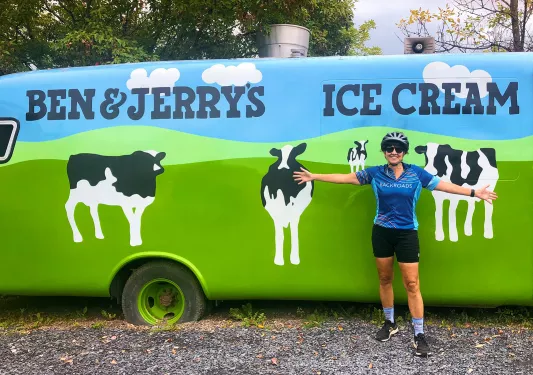 Guest posing in front of Ben & Jerry's car.