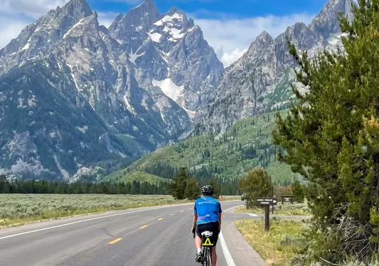 Backroads guests riding through rocky mountains on road