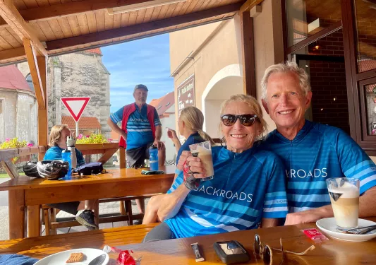 Bikers preparing for a bike ride over morning coffee and pastries.
