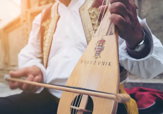 Close-up of local playing string instrument.