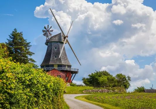 Windmill with dramatic clouds hovering over
