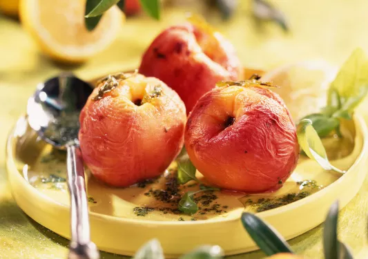 Platter of cooked peaches.