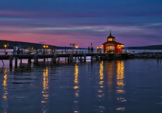 Wide shot of "SENECA LAKE" pier during sunset.