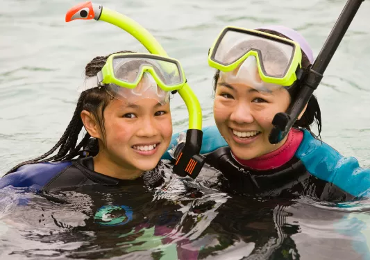 Close-up of two guests in snorkeling gear.