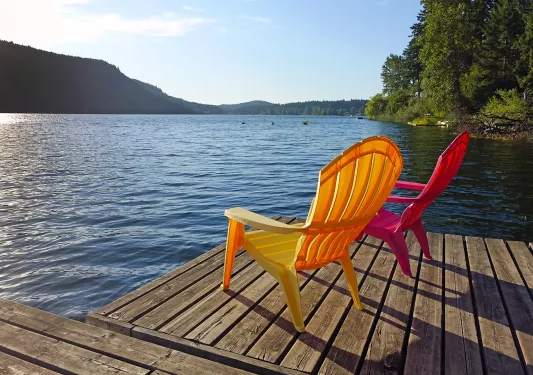 Shot of two chairs on a pier.