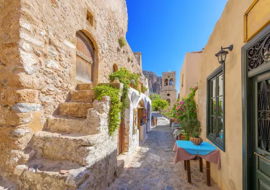 POV shot of someone walking down beachy stone alleyway.