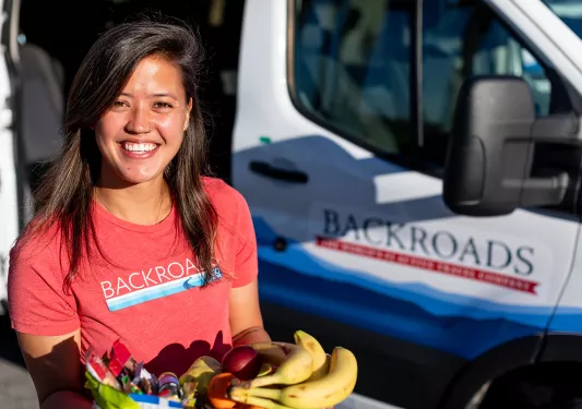 Backroads leader offering fruit on trip