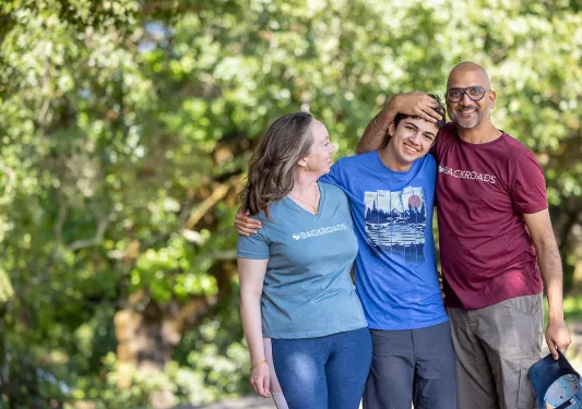 Three Backroads guests hugging, posing for photo.