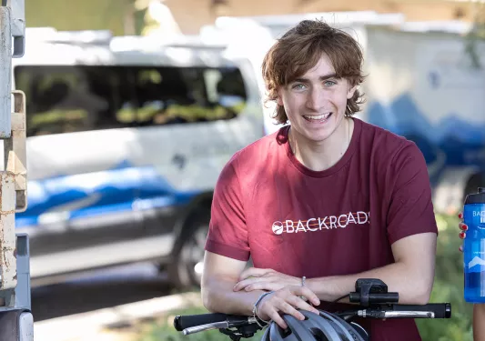 Guest/leader on bike, smiling for camera.