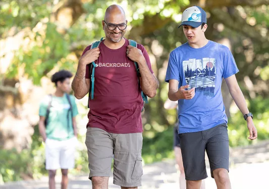Father and son hiking through a forest