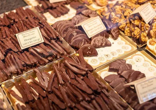 Close-up of confectionary shop. Chocolate orange peels, slices seen.