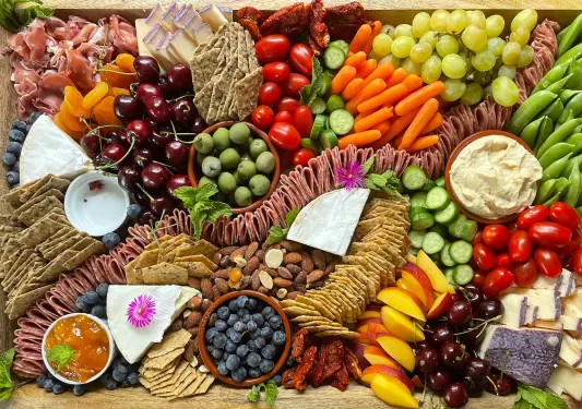 Charcuterie spread, meats, cheese, olives, crackers, nuts, etc.