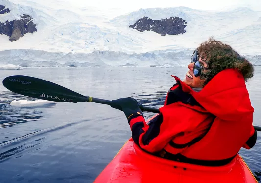 Person kayaking in the icy waters of Antarctica