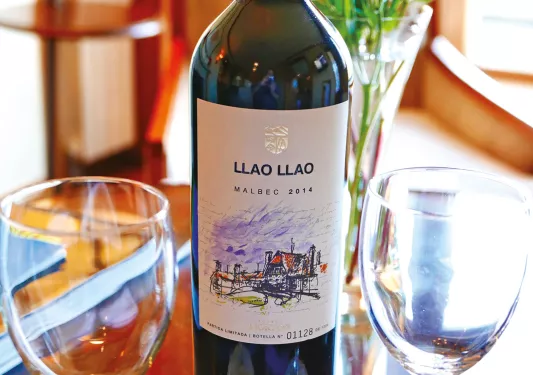 Shot of Liao Liao wine bottle, empty glasses.