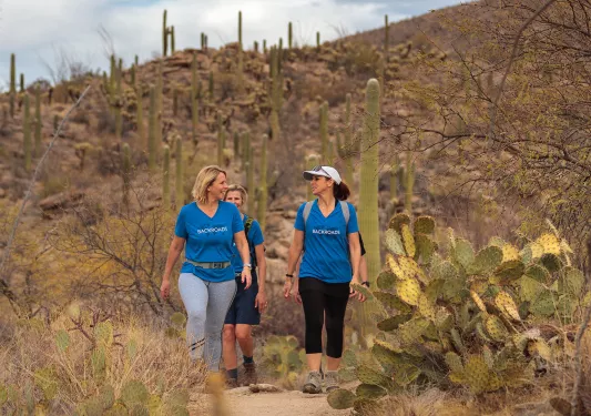 Women hikers in blue backroads shirts talking 
