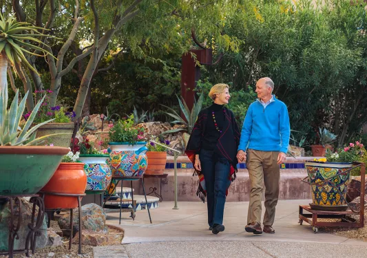 Couple holding hands walking in patio AZ