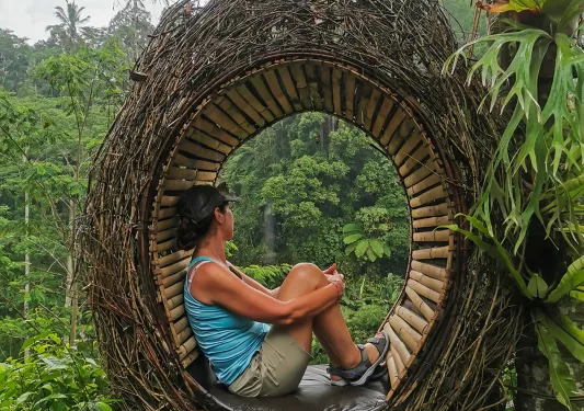 Shot of guest in wicker swing-type seat. Resembles tear drop shaped bird's nest.