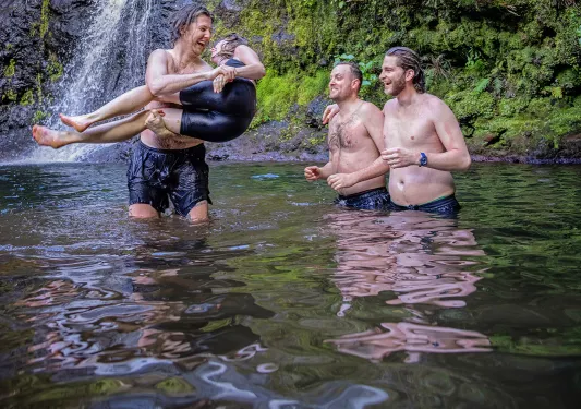 Guests Enjoying Pond in Front of Waterfall
