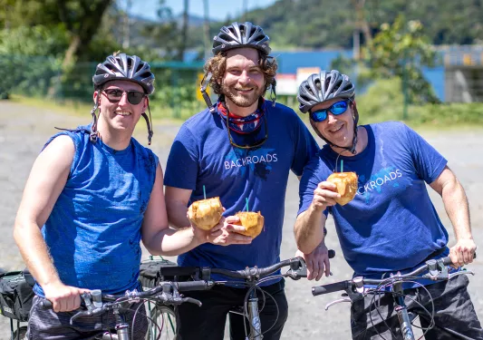 Three Guests Enjoying Coconuts