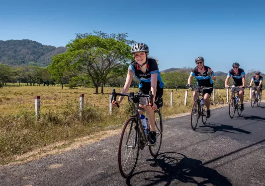 Backroads Kitted Guests Biking Single File 