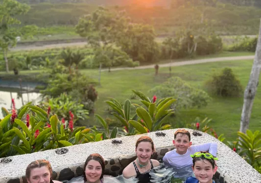 Guests In Pool During Sunset