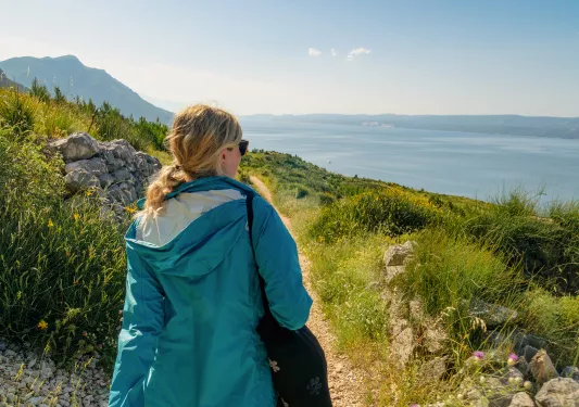 Guest on hillside walking towards ocean.